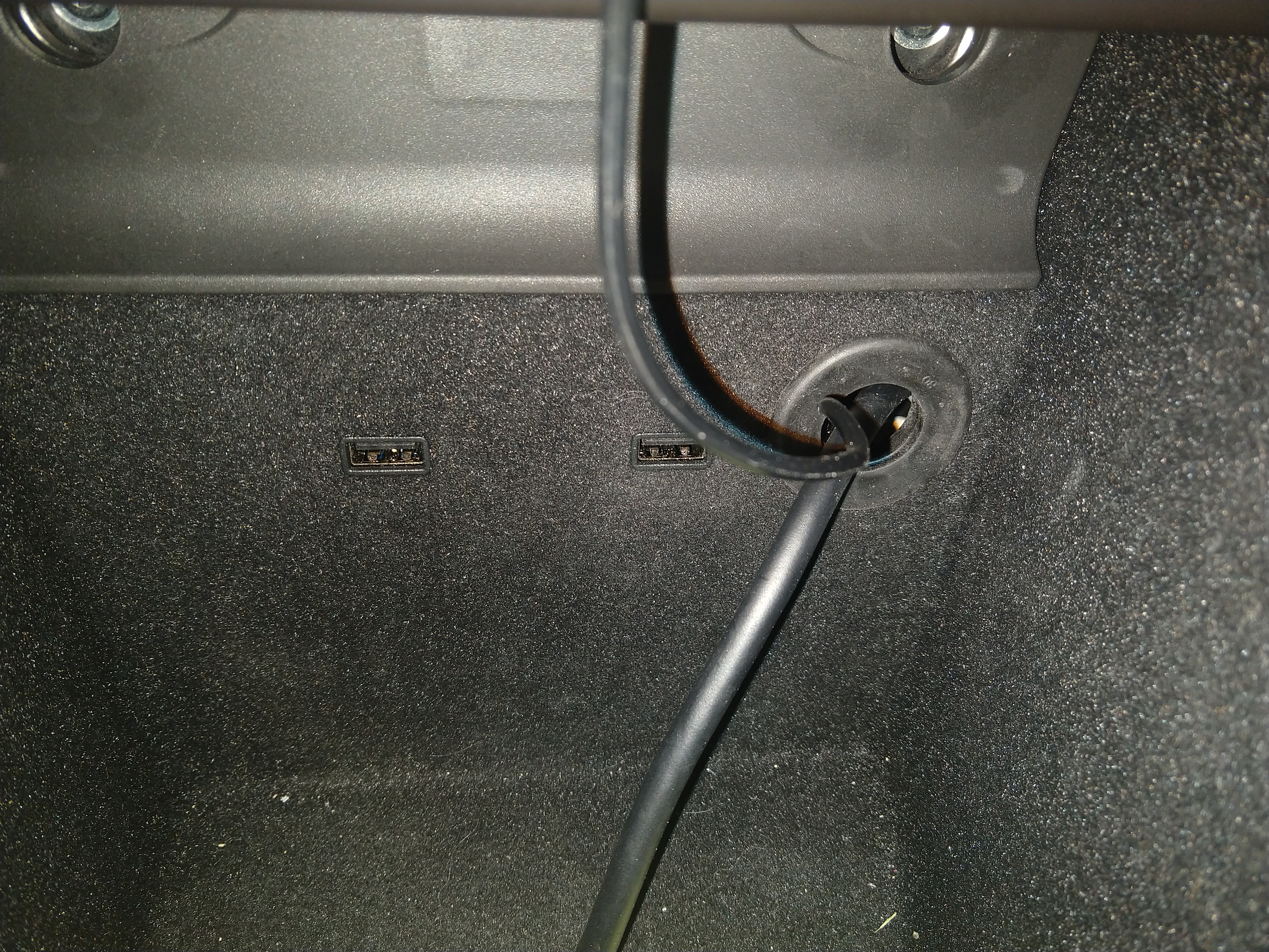 grommeted hole through center console