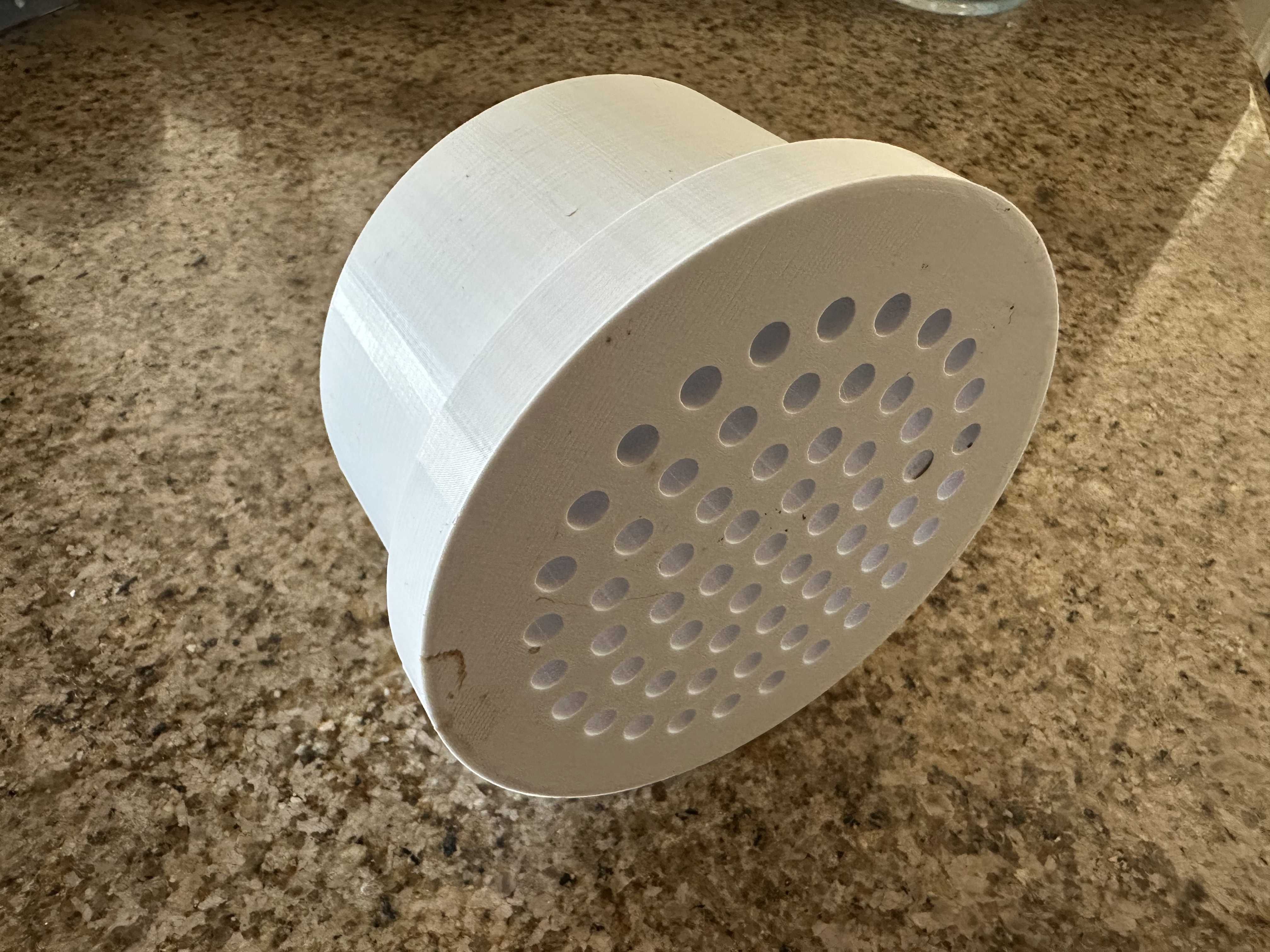 white vent tube cap with small holes for drainage