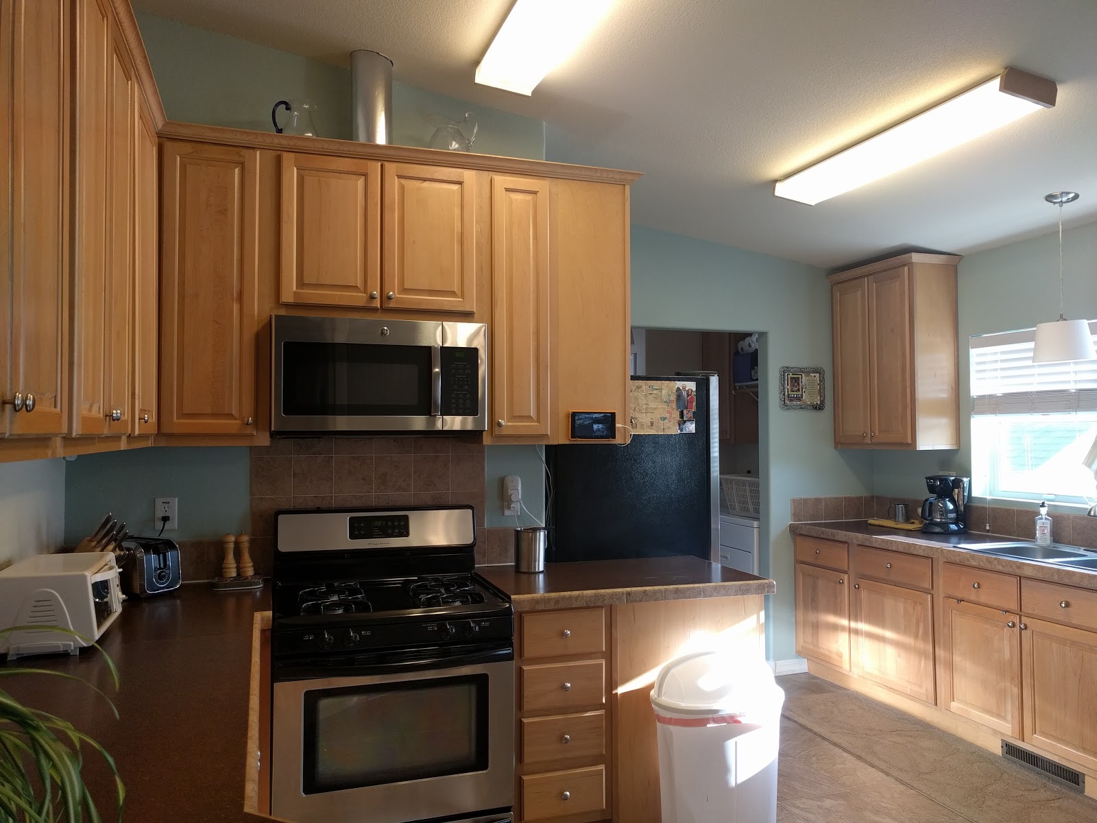 kitchen with over-the-range microwave and vent tube extending up into ceiling